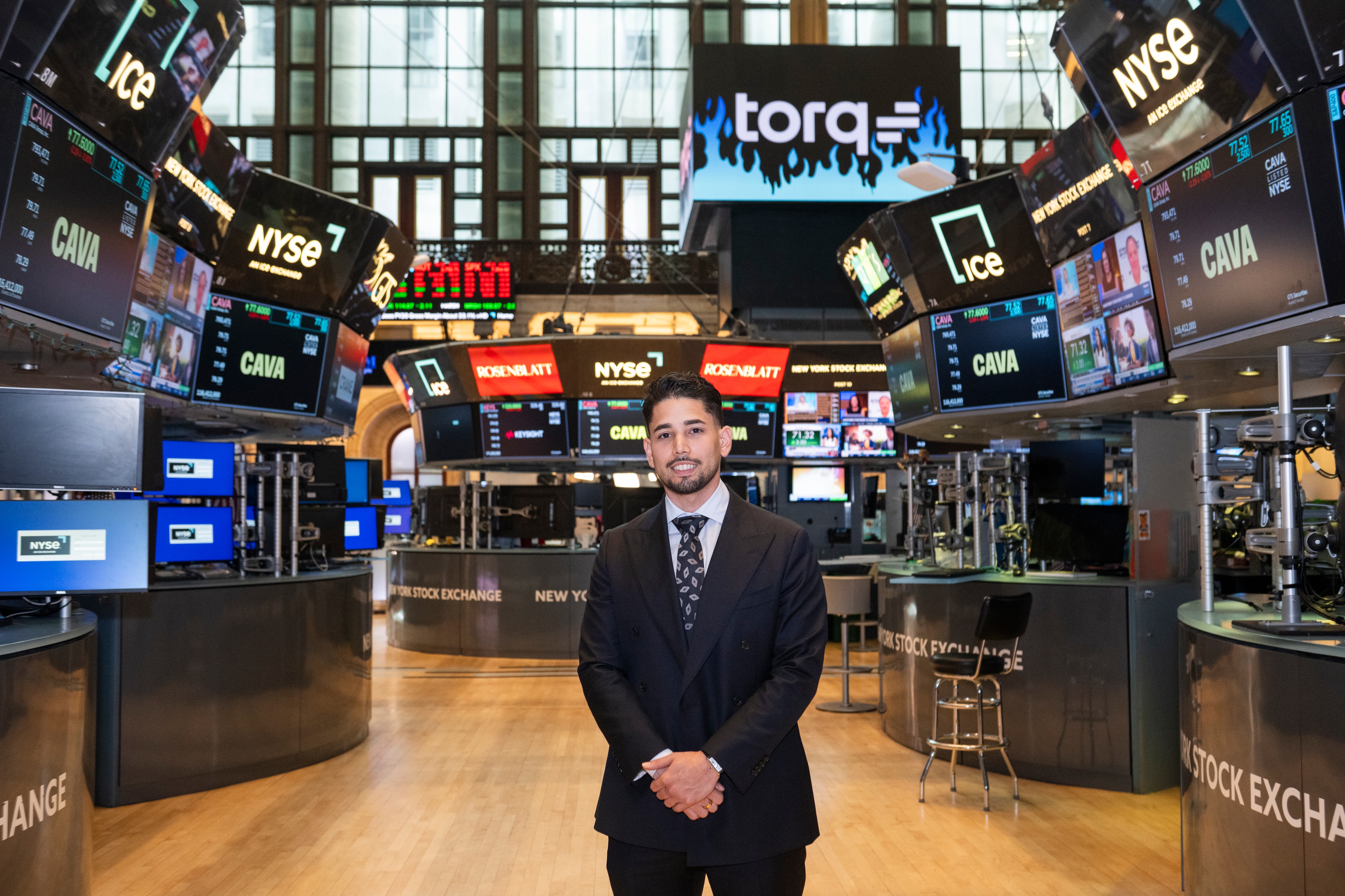 Omar Hafez standing on the New York Stock Exchange trading floor